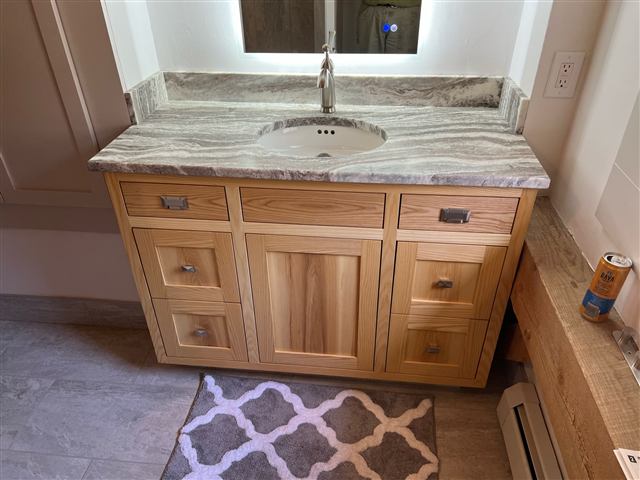 Custom wood vanity with a veined stone countertop