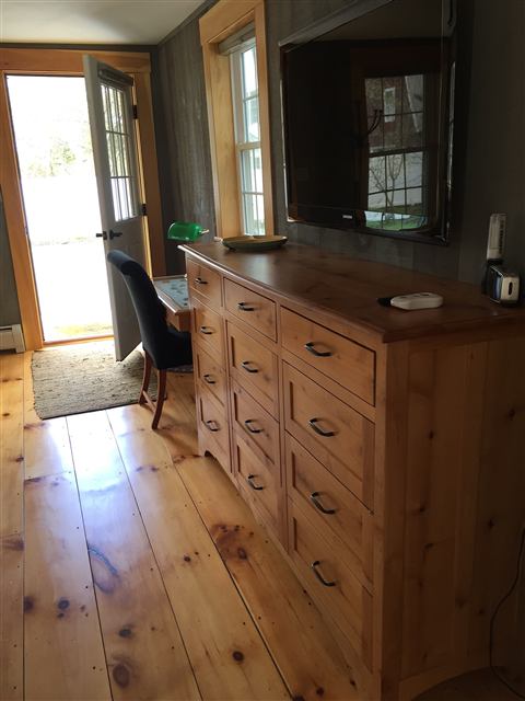 Custom multi-drawer cabinet on wide-plank floors