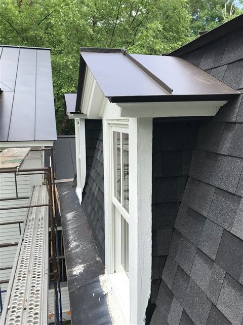 Dormer with a metal roof and trimmed window