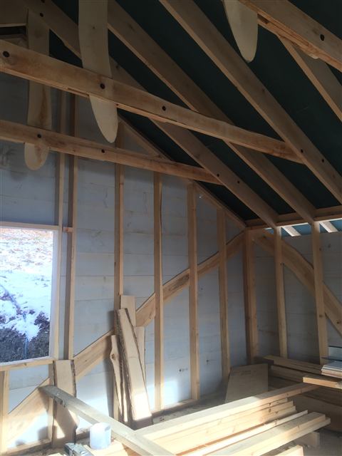 Interior framing of a new addition with exposed rafters