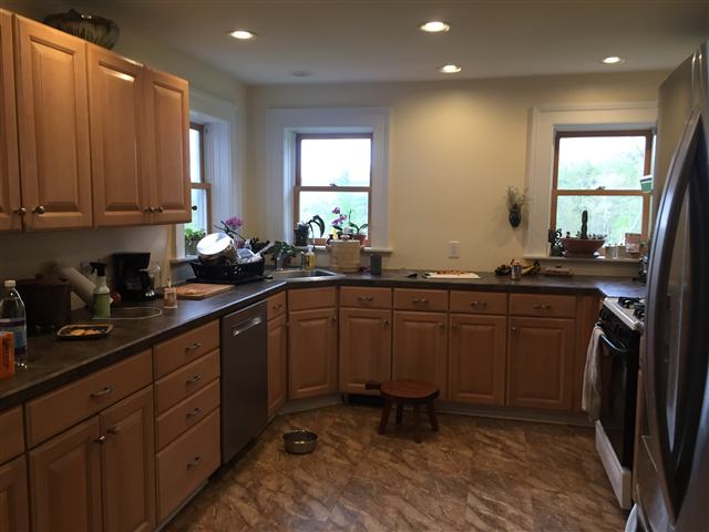 Finished kitchen with wood cabinets and recessed lighting