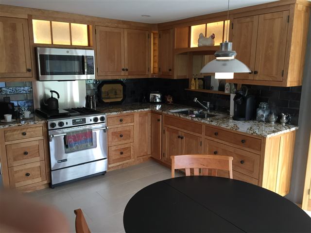 Kitchen with custom wood cabinets and a range