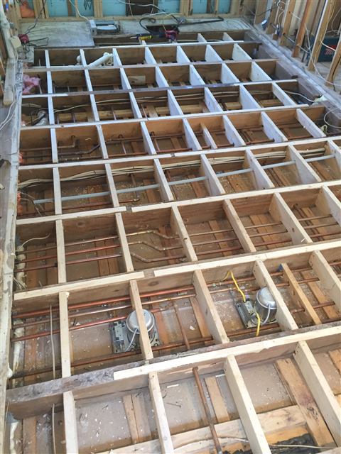 New floor framing exposed during a remodel